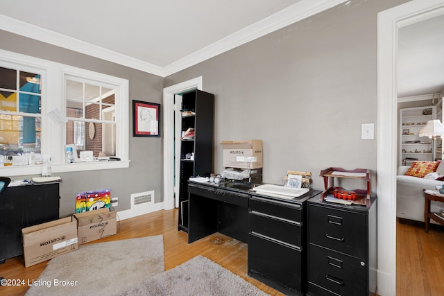 office featuring crown molding and light hardwood / wood-style flooring