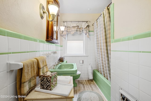 full bathroom featuring vanity, toilet, shower / bathtub combination with curtain, and tile walls