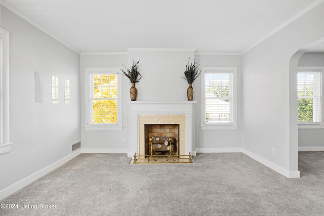 unfurnished living room featuring ornamental molding, a fireplace, and light colored carpet