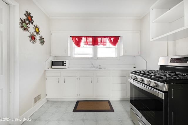 kitchen with gas stove, crown molding, white cabinets, and sink