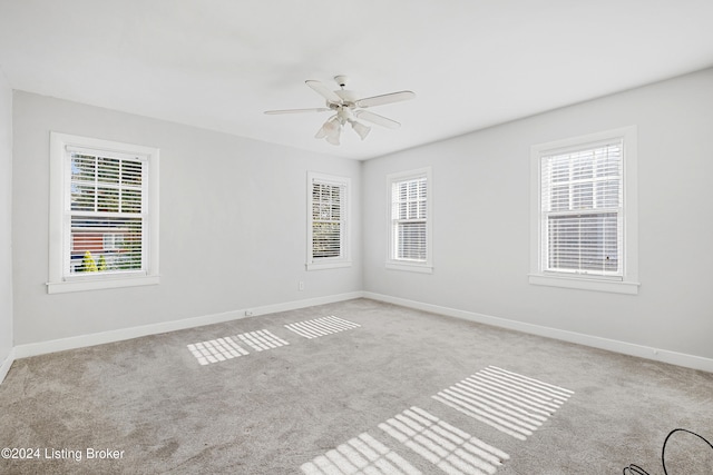 empty room with light carpet, plenty of natural light, and ceiling fan