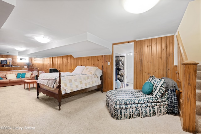 carpeted bedroom with wood walls