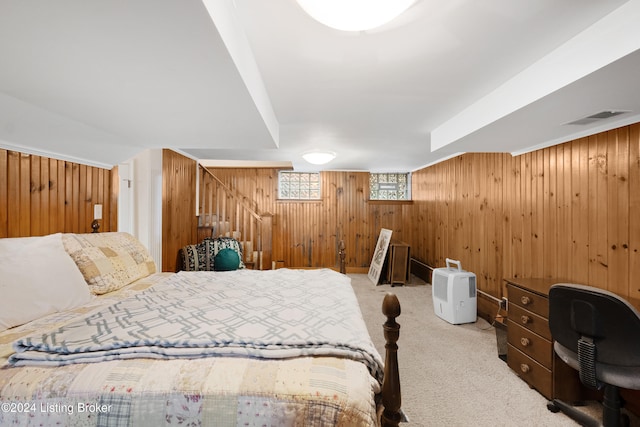 carpeted bedroom with wooden walls