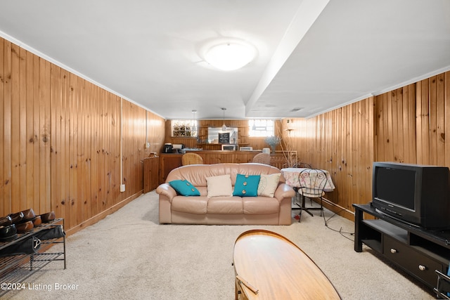 carpeted living room with ornamental molding and wooden walls