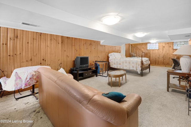 carpeted bedroom with wood walls