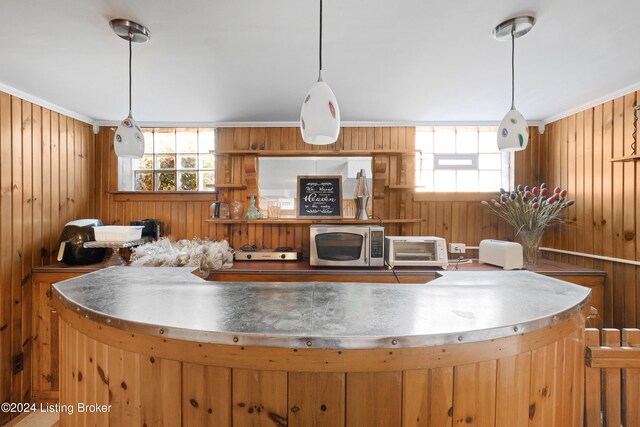 kitchen with wood walls and plenty of natural light