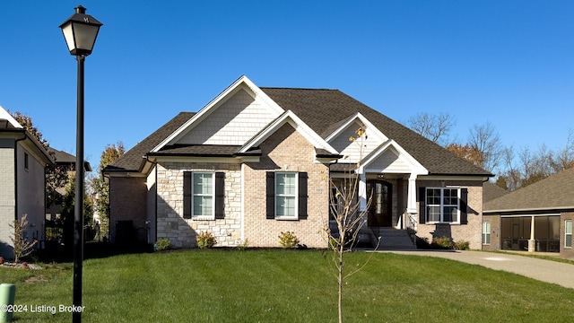 view of front facade with a sunroom and a front yard