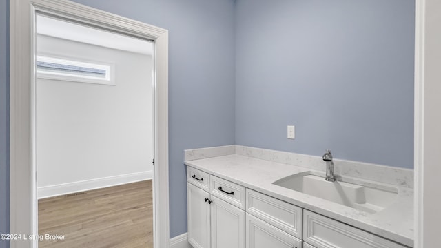 bathroom with wood-type flooring and vanity