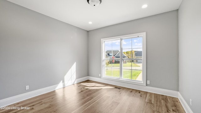 empty room with light hardwood / wood-style flooring