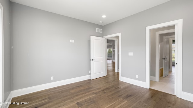 unfurnished bedroom with dark wood-type flooring