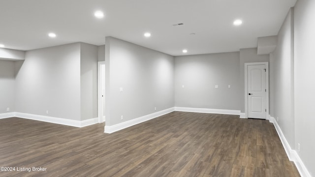 unfurnished room featuring dark wood-type flooring