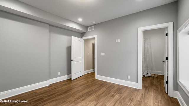 unfurnished bedroom with hardwood / wood-style floors