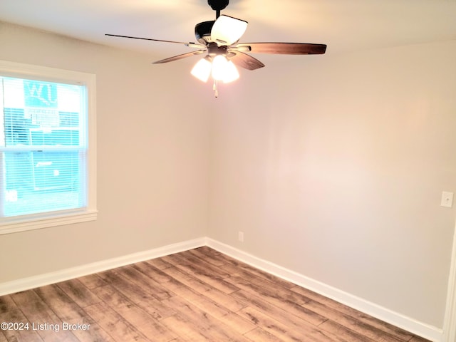 unfurnished room with ceiling fan and hardwood / wood-style flooring