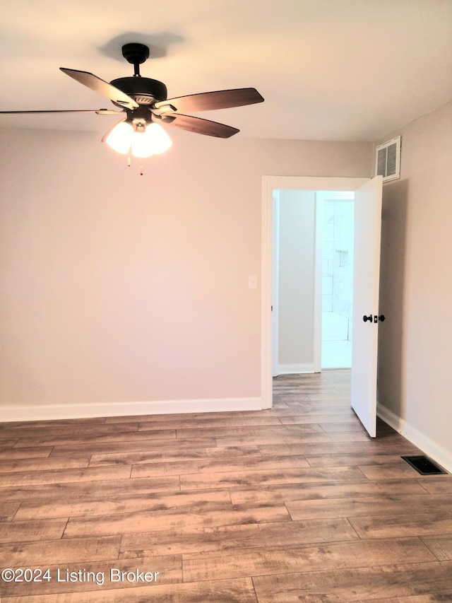 spare room with light hardwood / wood-style floors and ceiling fan