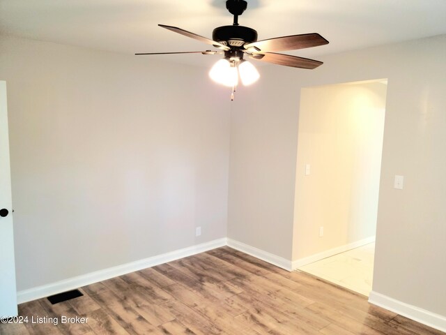 unfurnished room with ceiling fan and hardwood / wood-style flooring