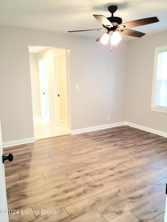 empty room featuring light wood-type flooring and ceiling fan