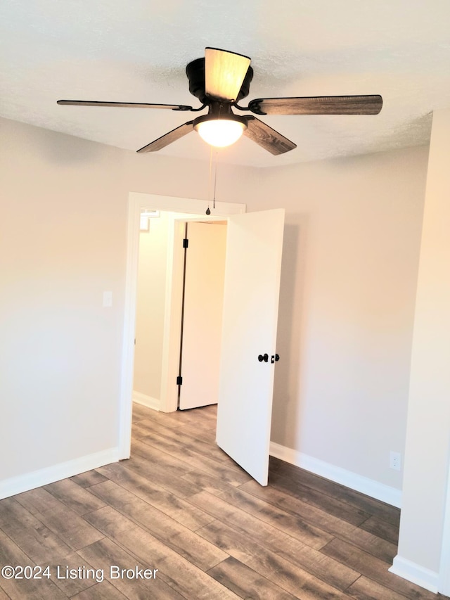 spare room featuring a textured ceiling, hardwood / wood-style flooring, and ceiling fan