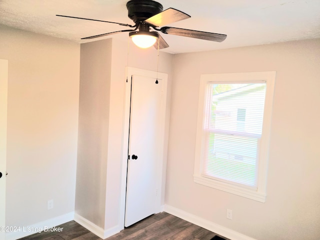 unfurnished bedroom featuring dark hardwood / wood-style floors and ceiling fan