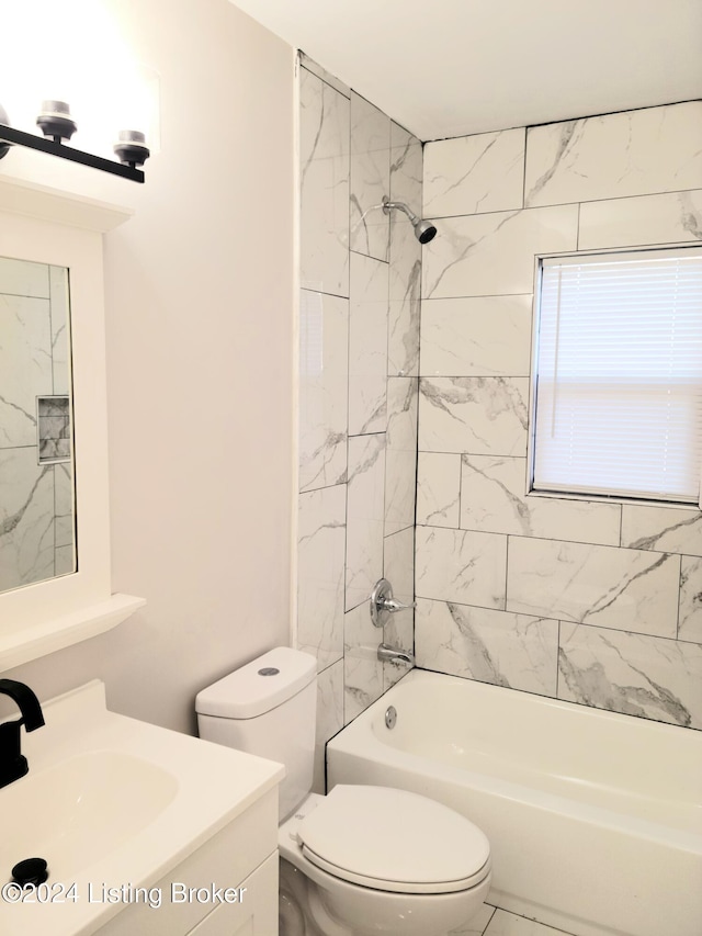 full bathroom featuring vanity, toilet, and tiled shower / bath combo