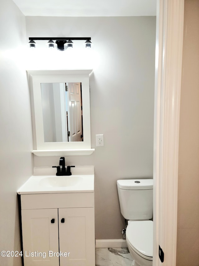 bathroom featuring vanity and toilet