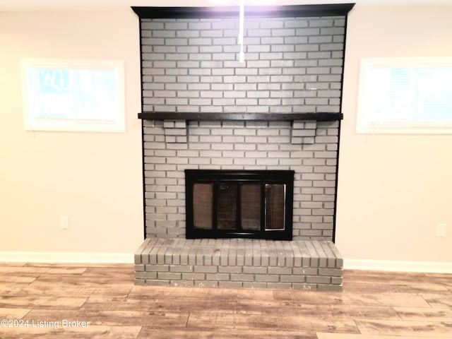 interior details with hardwood / wood-style floors and a fireplace