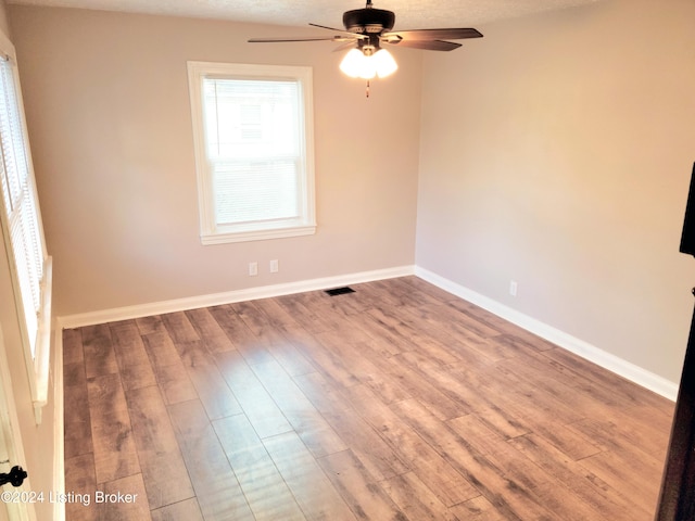 spare room featuring a textured ceiling, hardwood / wood-style flooring, and ceiling fan