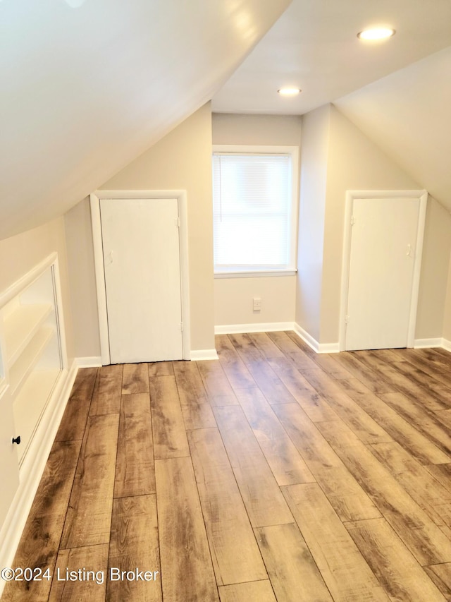 bonus room featuring vaulted ceiling and wood-type flooring