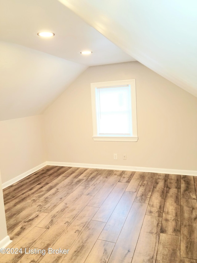 bonus room featuring lofted ceiling and wood-type flooring