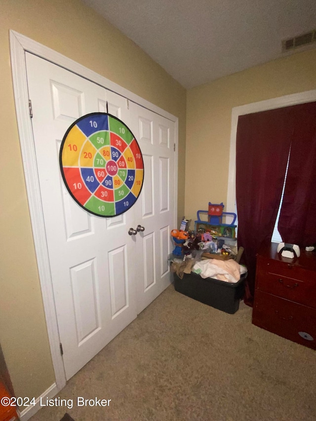 foyer entrance with carpet