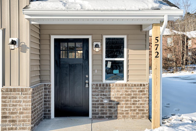 view of snow covered property entrance