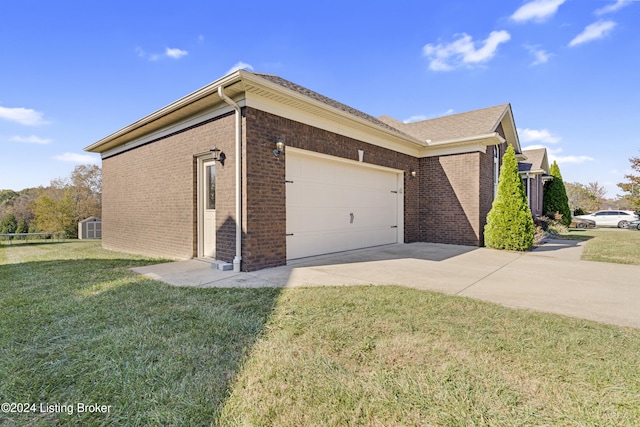 view of side of home with a yard and a garage