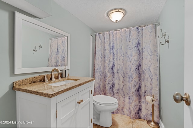 bathroom featuring vanity, a shower with curtain, a textured ceiling, and toilet