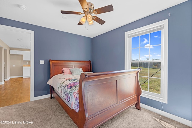 bedroom with light carpet and ceiling fan