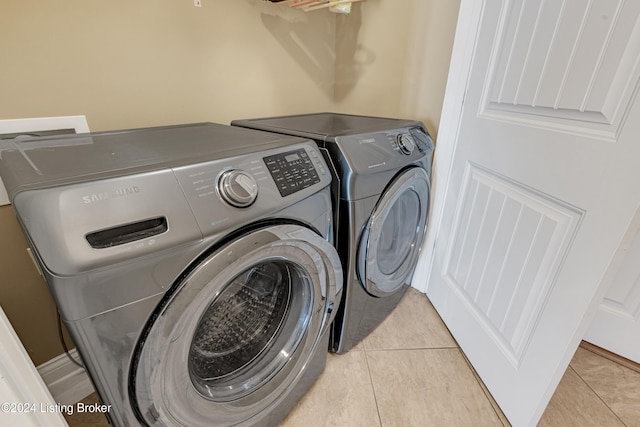 washroom featuring washer and dryer and light tile patterned floors