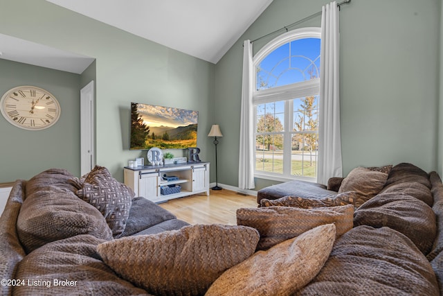 living room with vaulted ceiling and light wood-type flooring