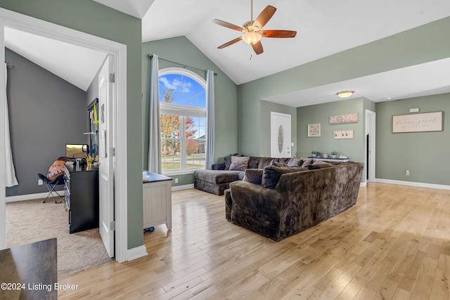 living room with ceiling fan, lofted ceiling, and light hardwood / wood-style flooring