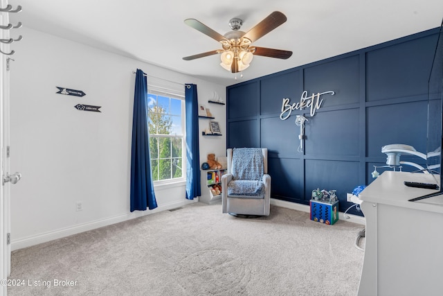 living area with ceiling fan and carpet floors