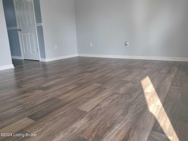 empty room with dark wood-type flooring