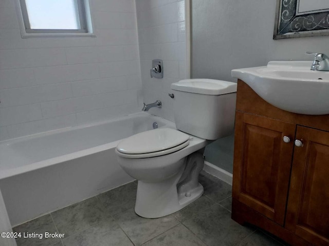 full bathroom featuring vanity, toilet, tile patterned flooring, and tiled shower / bath