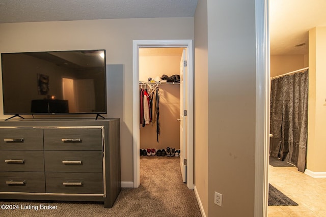 interior space with a textured ceiling and carpet floors