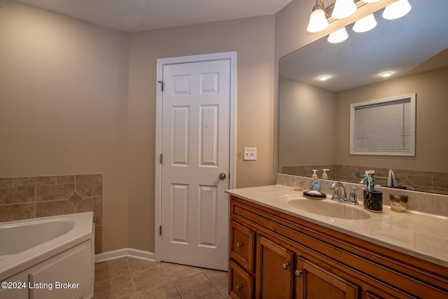 bathroom featuring tile patterned flooring, vanity, and a tub