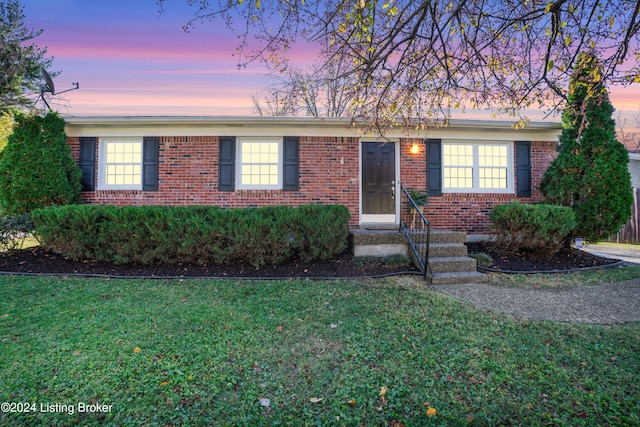 ranch-style house featuring a lawn