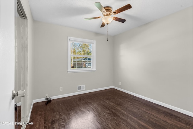 spare room with dark hardwood / wood-style floors and ceiling fan