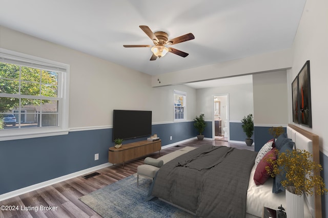 bedroom with ensuite bathroom, wood-type flooring, and ceiling fan