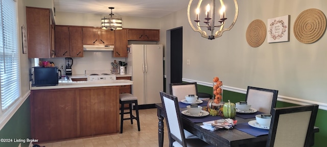 dining area featuring a notable chandelier