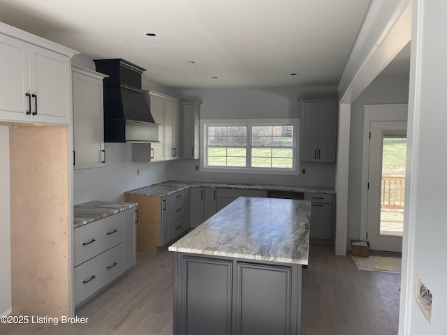 kitchen featuring gray cabinets, a kitchen island, and a wealth of natural light