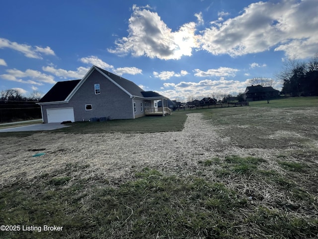 view of side of property featuring a yard and a garage