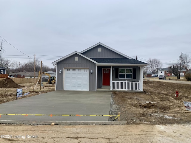 view of front of house with a garage, driveway, roof with shingles, and covered porch