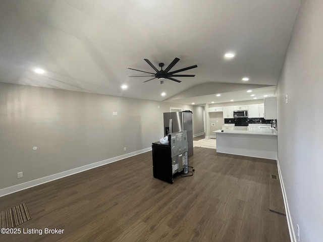 unfurnished living room featuring baseboards, dark wood-style floors, ceiling fan, vaulted ceiling, and recessed lighting