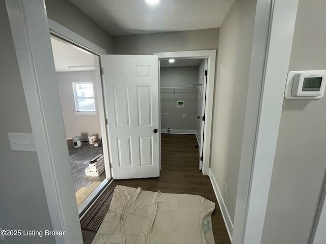 corridor with baseboards and dark wood-style flooring